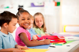 Girl smiling at the camera while sitting with friends